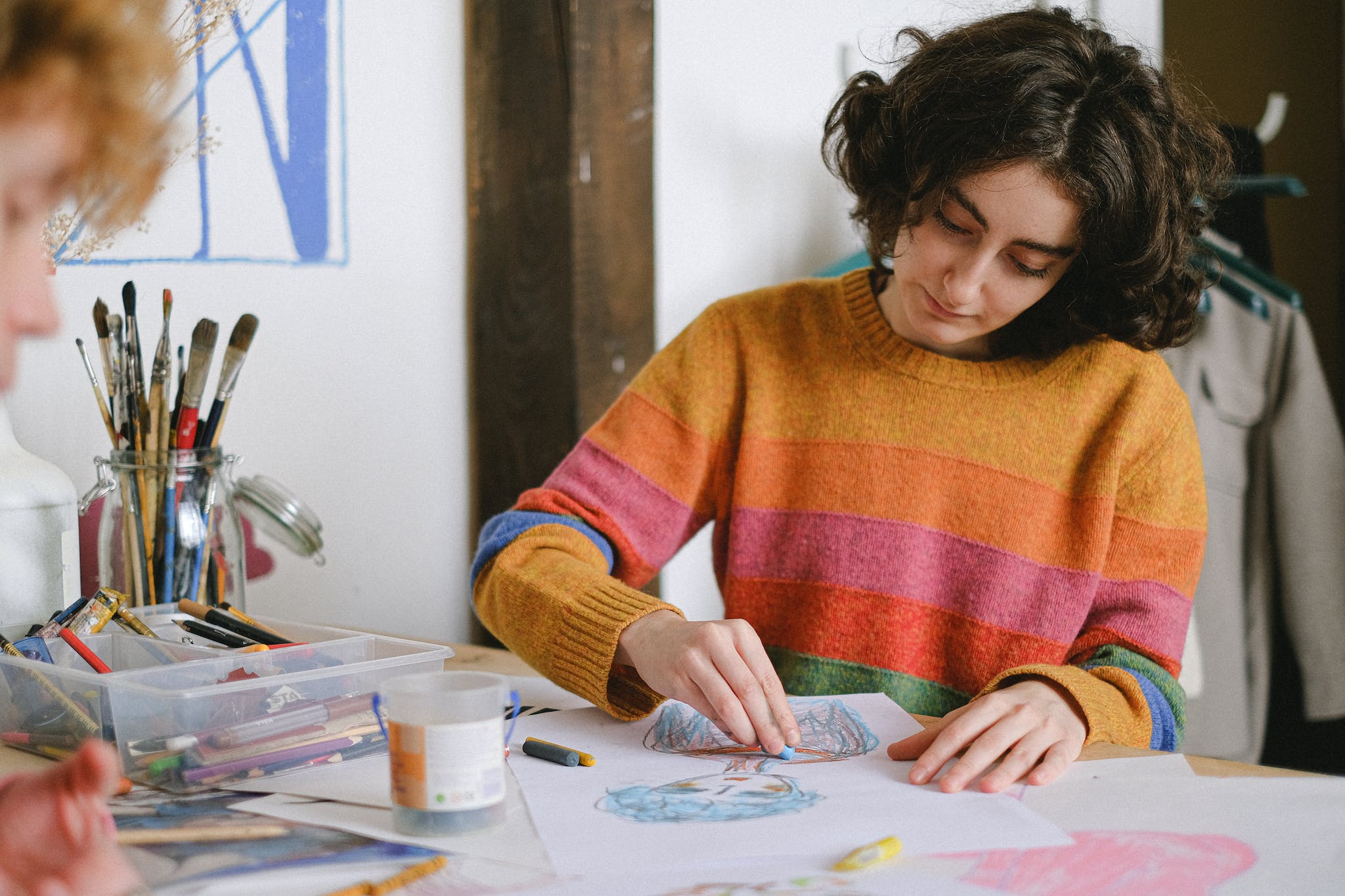 Focused woman drawing picture in studio